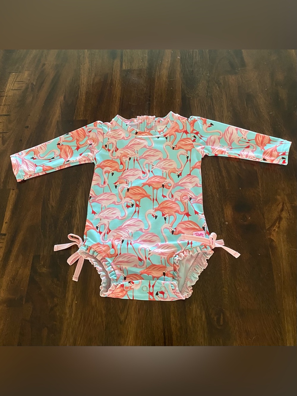 Ruffle Butts Pink Flamingo Long-Sleeve Rash Guard on Aqua